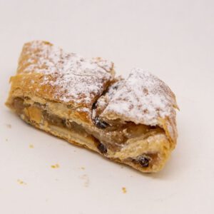 Baked apples and raisins wrapped in streudel pastry dusted with powdered sugar.